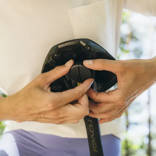 KeyBudz Covert Mount för AirTag, rund svart hållare med kant som monteras mellan sadelrälsen för hand under en cykelsadel.